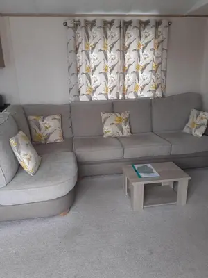 a living room with a couch and a coffee table at 2 bed 2 ensuite Holiday Home in St Austell
