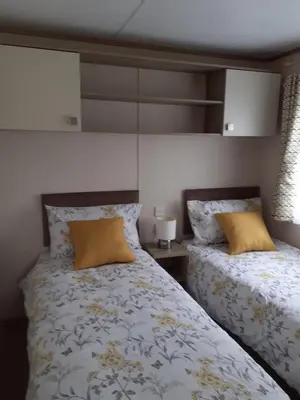 two beds sitting next to each other in a bedroom at 2 bed 2 ensuite Holiday Home in St Austell