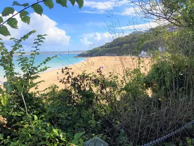 a view of a beach with people in the water at Penny's Place in Carbis Bay