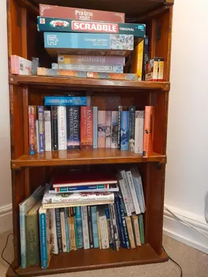 a book shelf filled with lots of books at Penny's Place in Carbis Bay