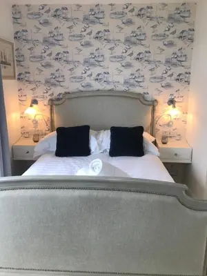 a bedroom with a bed with two pillows on it at Seagulls Boutique Lodgings in Mevagissey