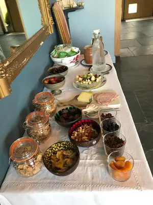 a table with many different bowls of food on it at Seagulls Boutique Lodgings in Mevagissey