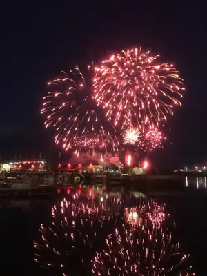 a firework display over the water at night at Seagulls Boutique Lodgings in Mevagissey