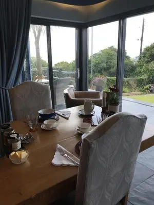 a wooden table with chairs around it with a view at Seagulls Boutique Lodgings in Mevagissey