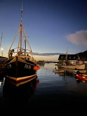 a boat is docked in the water in a harbor at Seagulls Boutique Lodgings in Mevagissey