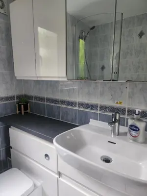 a bathroom with a white sink and a mirror at Hayle holiday cottage in Hayle