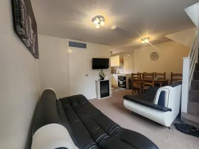 a living room with a black and white couch at Hayle holiday cottage in Hayle