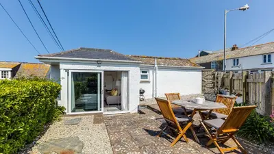 a small patio with a table and chairs at The Lobster Pot in Port Isaac