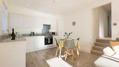 a kitchen and dining room with a table and chairs at The Lobster Pot in Port Isaac