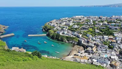 an aerial view of a town with boats in the water at The Lobster Pot in Port Isaac