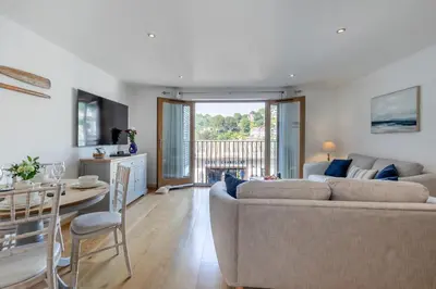 a living room with a couch and a table at 2 Bed in Looe oc-n29477 in Looe
