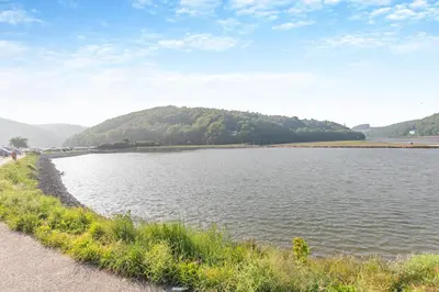a large body of water with a hill in the background at 2 Bed in Looe oc-n29477 in Looe