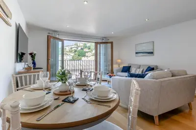 a living room with a table and a couch at 2 Bed in Looe oc-n29477 in Looe