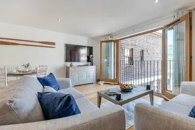 a living room with a couch and a table at 2 Bed in Looe oc-n29477 in Looe