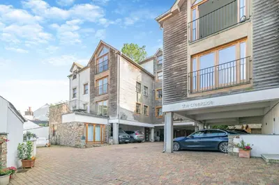 an apartment building with a car parked in a parking lot at 2 Bed in Looe oc-n29477 in Looe