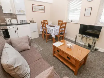 a living room with a couch and a table at Greenwood Apartment in St Ives