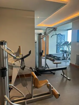 a gym with several exercise equipment in a room at Porthminster View Luxury Sea Views Balcony, Parking, Pool, Spa & Gym in St Ives