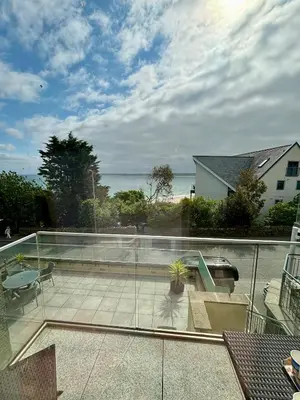 a balcony with a view of the ocean from a house at Porthminster View Luxury Sea Views Balcony, Parking, Pool, Spa & Gym in St Ives