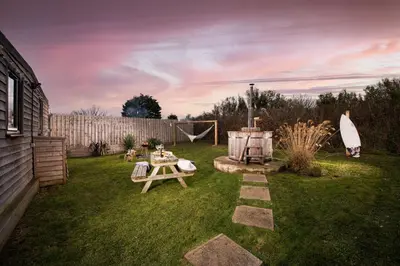 a backyard with a picnic table and a grill at Wheal Prosper - Hot Tub - Free Wi-Fi - Parking - On-site Activities in Helston