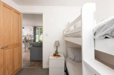 a bedroom with a bunk bed and a staircase at Wheal Prosper - Hot Tub - Free Wi-Fi - Parking - On-site Activities in Helston