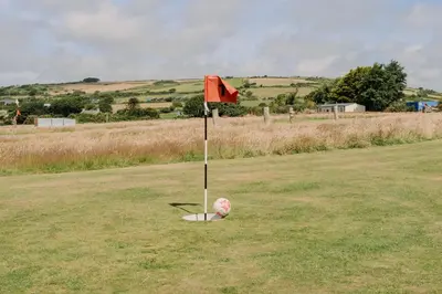 a pole in the middle of a field with a flag at Wheal Prosper - Hot Tub - Free Wi-Fi - Parking - On-site Activities in Helston