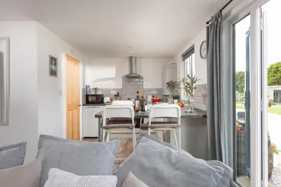 a kitchen with a table and chairs in a room at Wheal Jewel - Hot Tub - On-site Activities - Free WiFi - Parking in Helston