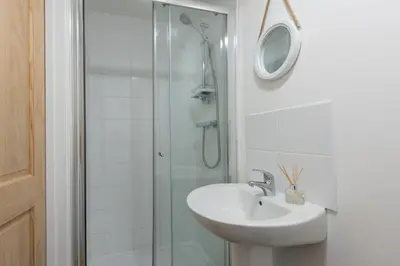 a bathroom with a sink and a glass shower at Wheal Jewel - Hot Tub - On-site Activities - Free WiFi - Parking in Helston