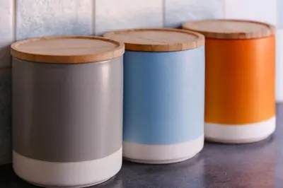 a group of three containers sitting on a table at St Anthony Cottage in Saint Mawes