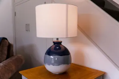 a lamp on a table with a lamp on it at St Anthony Cottage in Saint Mawes