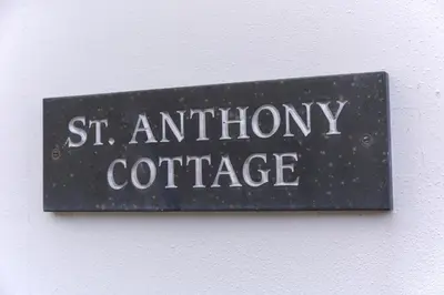 a sign on a wall that reads st antolphometryate at St Anthony Cottage in Saint Mawes