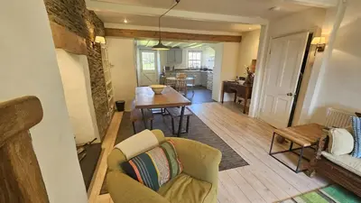 a living room with a couch and a table at Tregongon House in Veryan