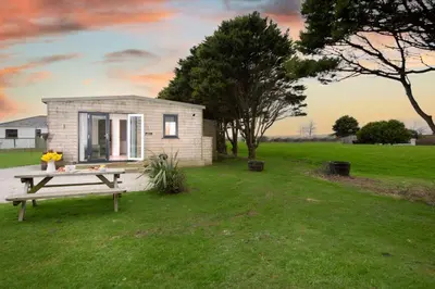 a tiny house with a picnic table in the yard at Bushwood - Free WiFi - Parking - Pet Friendly - On-site Activities in Helston