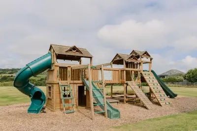 a playground with a slide and a slideintend at Bushwood - Free WiFi - Parking - Pet Friendly - On-site Activities in Helston