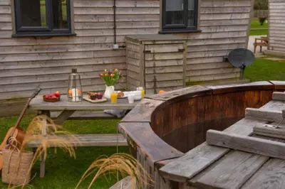 a picnic table in a yard next to a house at Wheal Rose - Hot Tub - Parking - Free WiFi - On-Site Activities in Helston