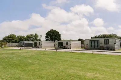a group of three mobile homes in a field at Wheal Amelia - Free WiFi - Parking - Pet Friendly - On-site Activities in Helston
