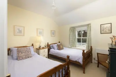 a bedroom with two beds and a window at Deugh an Chy in Carleen