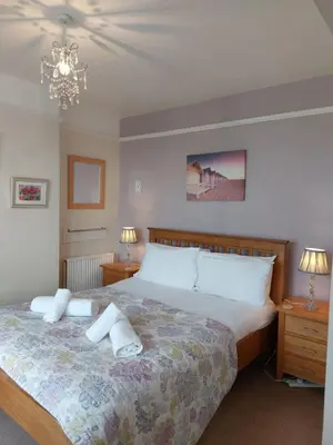 a bedroom with a large bed with towels on it at Porthmeor Beach 150 m Parking 2-3 cars in St Ives