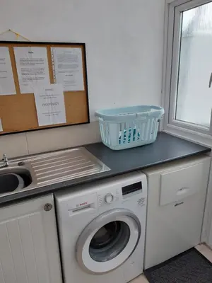 a laundry room with a washing machine and a sink at Porthmeor Beach 150 m Parking 2-3 cars in St Ives