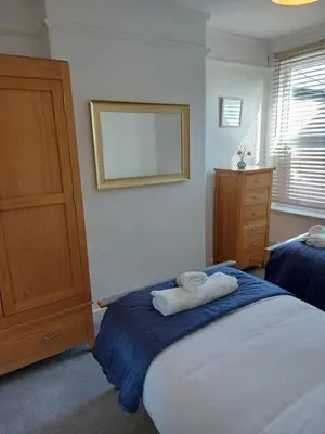 a bedroom with two towels sitting on a bed at Porthmeor Beach 150 m Parking 2-3 cars in St Ives