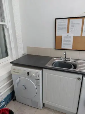 a kitchen with a washing machine and a sink at Porthmeor Beach 150 m Parking 2-3 cars in St Ives
