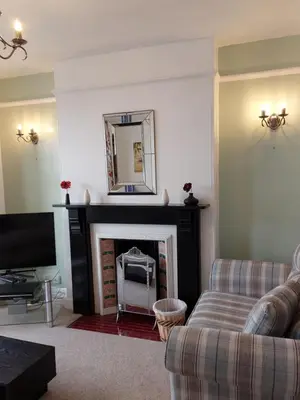 a living room with a couch and a fireplace at Porthmeor Beach 150 m Parking 2-3 cars in St Ives