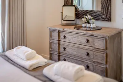 a bedroom with a dresser with a mirror and towels at 2 Bed in Padstow oc-t29016 in Padstow