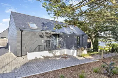 a gray brick house with a ramp in front of it at 2 Bed in Padstow oc-t29016 in Padstow