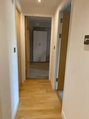 an empty hallway with a hallway leading to a room at Modern apartment, Fistral beach in Newquay