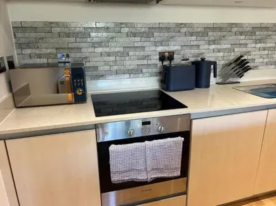 a kitchen with a stove and a counter top at Modern apartment, Fistral beach in Newquay