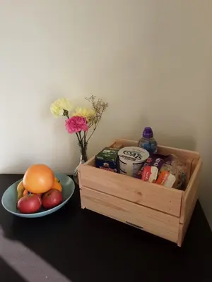 a wooden crate next to a bowl of fruit and a plate of food at Freda's Treasure 