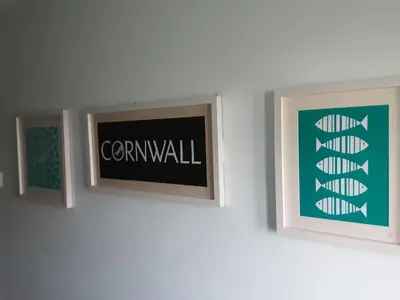 two picture frames on a wall with the word comwell at Freda's Treasure 