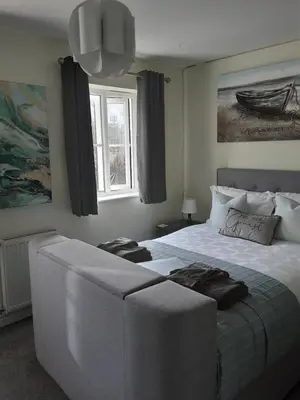 a bedroom with a large bed and a window at Freda's Treasure 