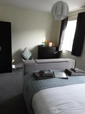 a bedroom with a bed with two robes on it at Freda's Treasure 