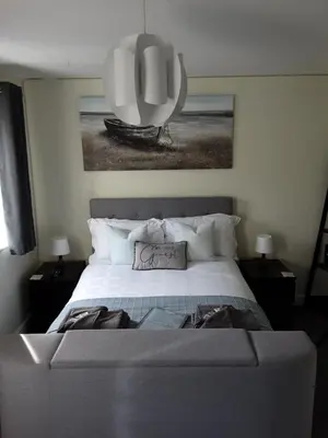 a bedroom with a large bed and a large mirror at Freda's Treasure 